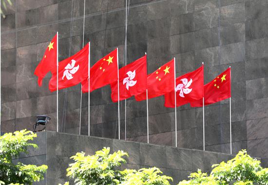 The Chinese national flags and flags of the Hong Kong SAR flutter in Hong Kong. (Photo/Xinhua)